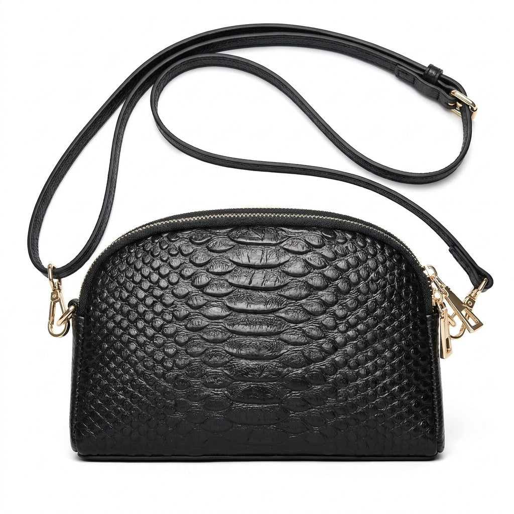 Front view of the Isaure black croc-embossed leather half-moon crossbody bag with gold-tone hardware