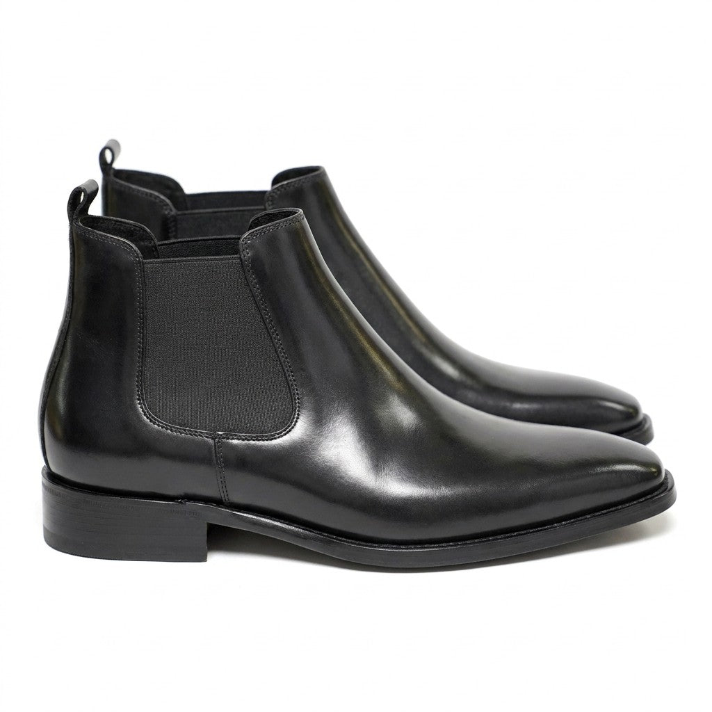 Pair of black polished Jasper men's Chelsea boots with chisel toe, side view on white