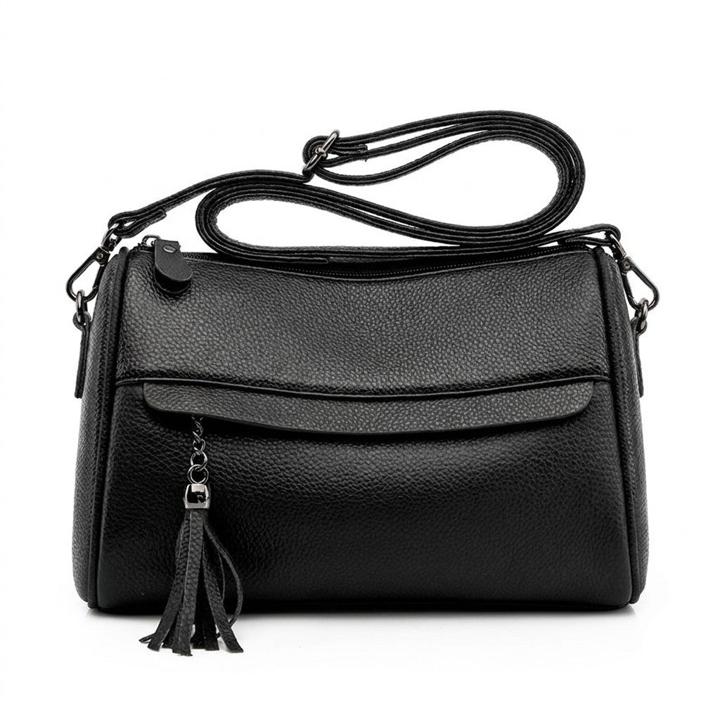 Front view of the Odalys black pebbled leather barrel crossbody bag with tassel on a white background