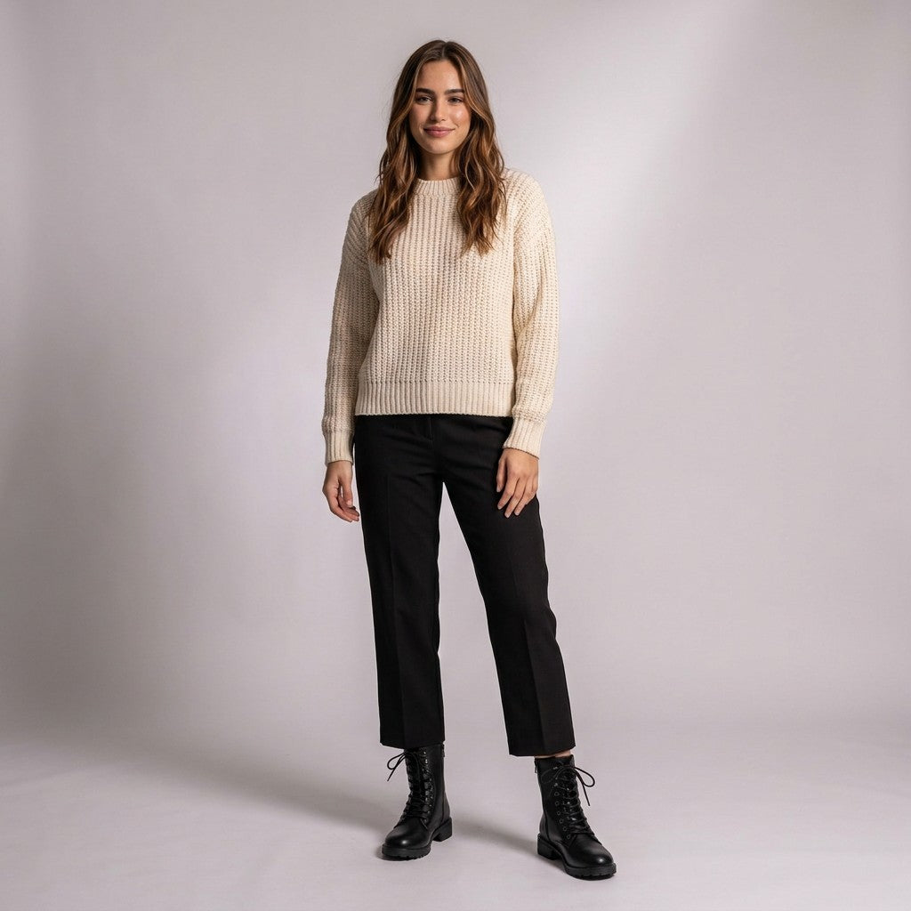 Model in a cream jumper and cropped black trousers wearing Lysandra lace up boots