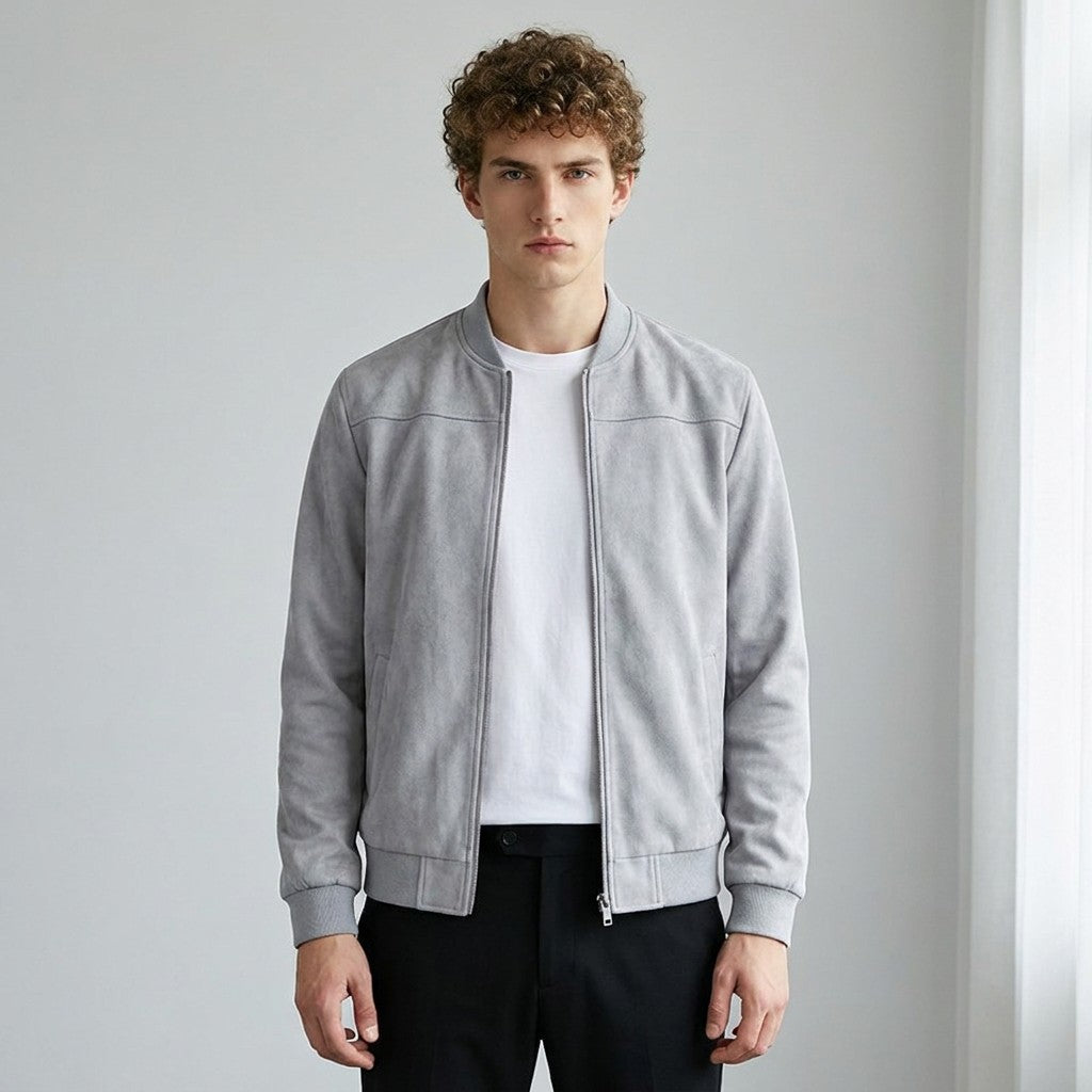 Model wearing the grey Corvin suede bomber open over a white T-shirt with black trousers