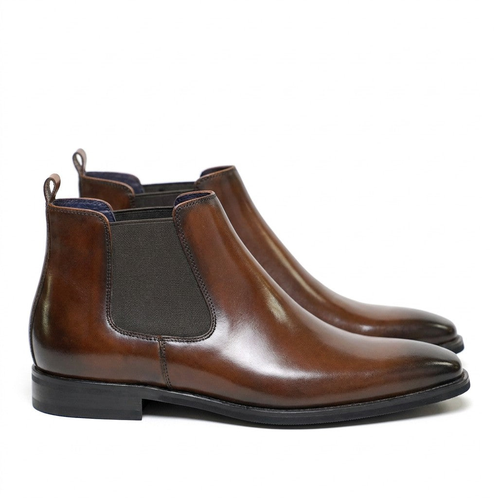 Pair of burnished brown Jasper Chelsea boots with stacked heel on white