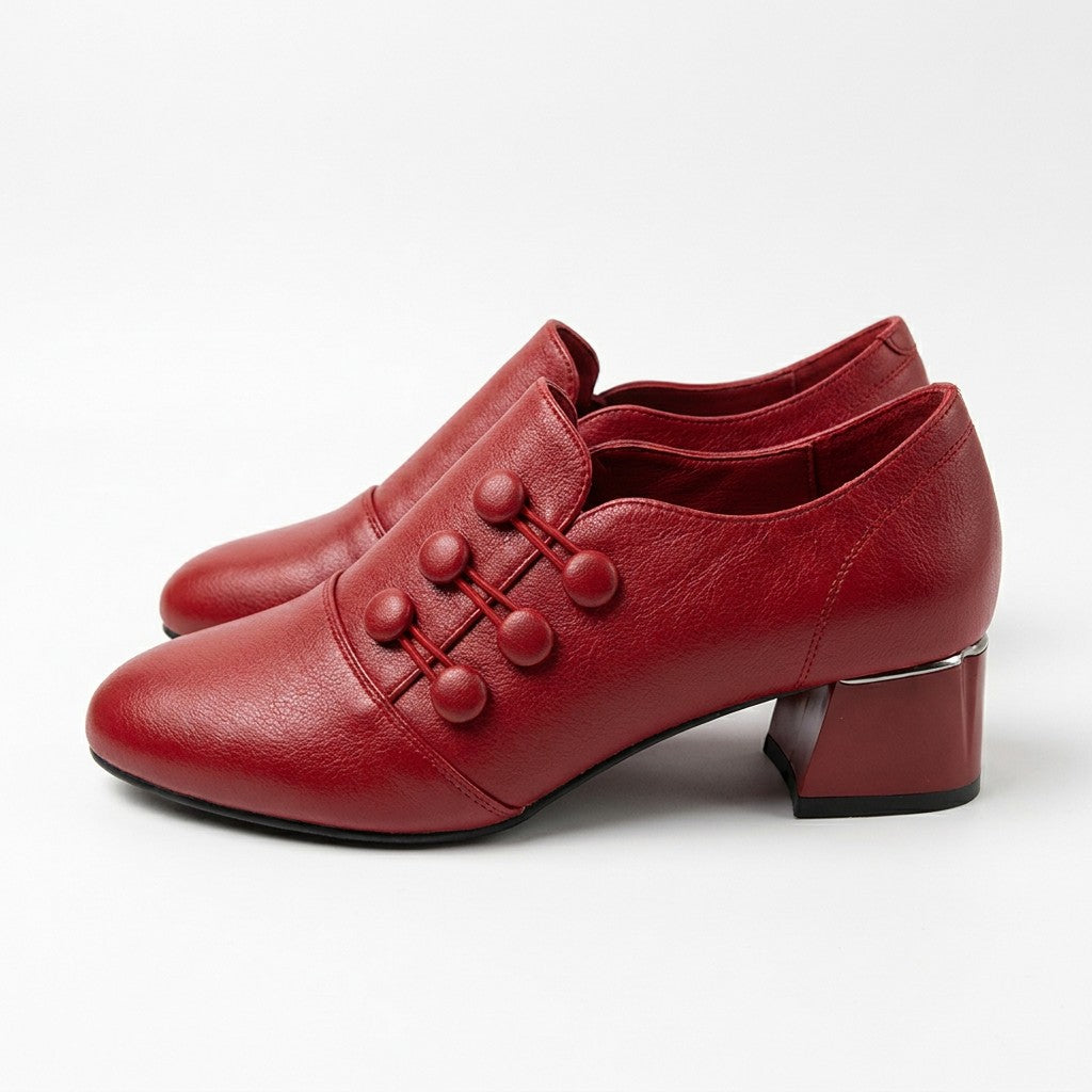 Pair of red Clemence shoe boots with block heels and silver trim on white