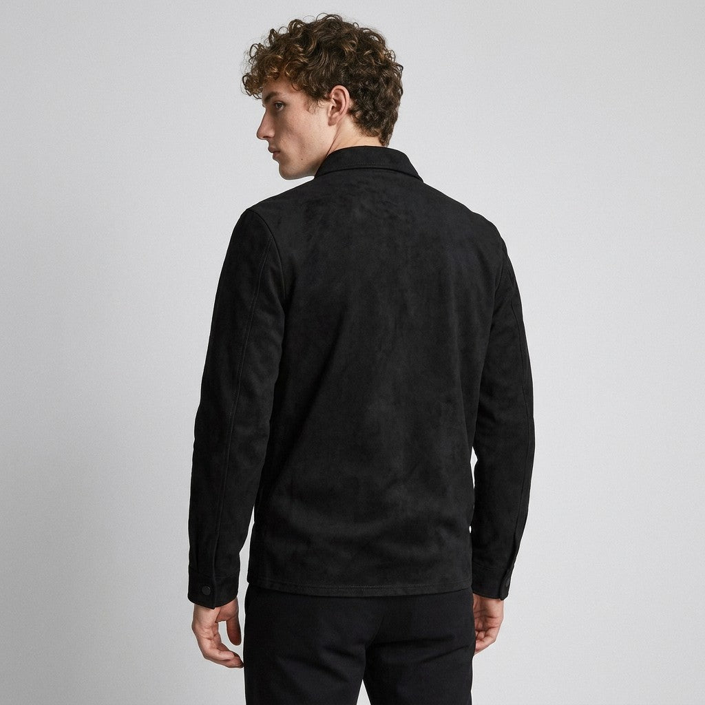 Back view of the black Dorian shirt jacket on a model, plain back and snap cuffs