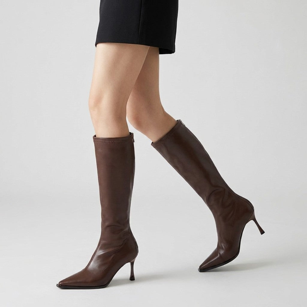 Brown Maribel boots in motion, side view showing the slim shaft and stiletto heel