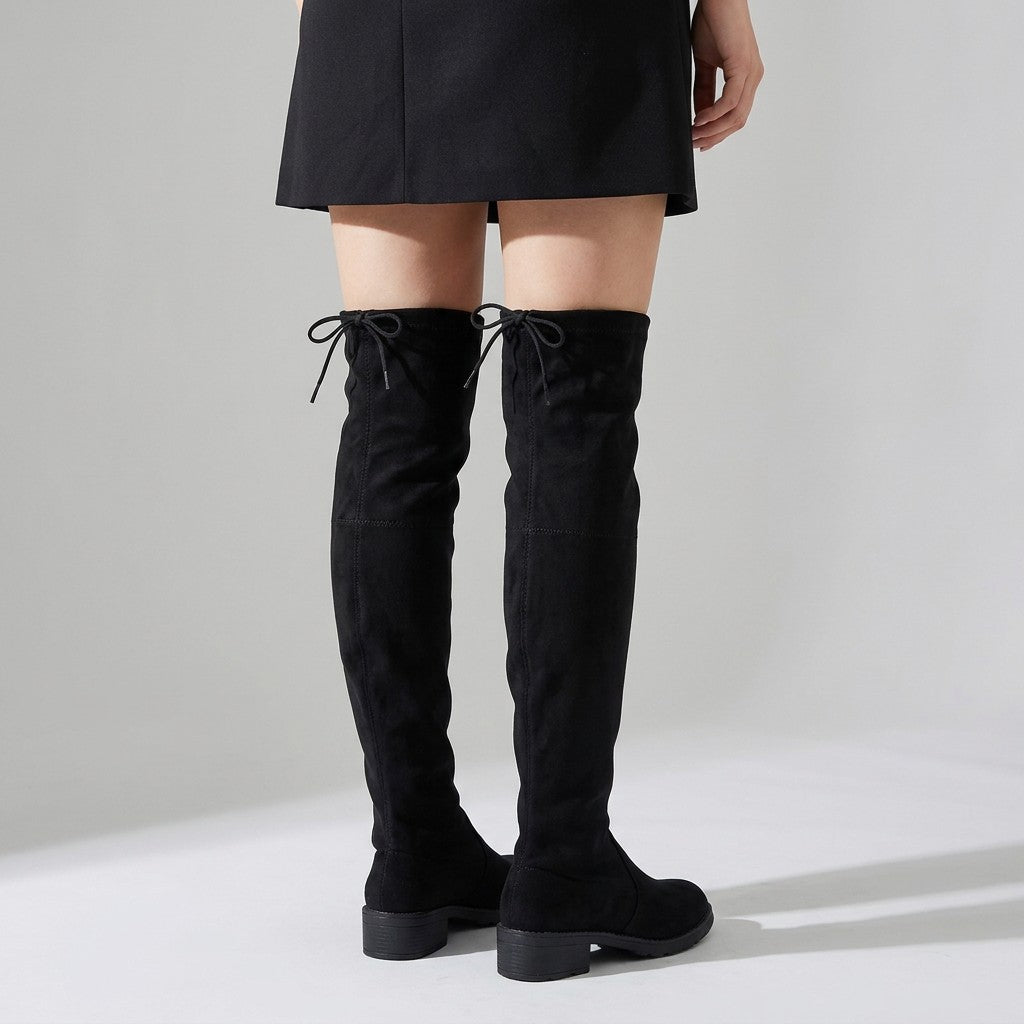 Back view of Oriane over-the-knee boots worn with a short skirt, drawstring ties visible
