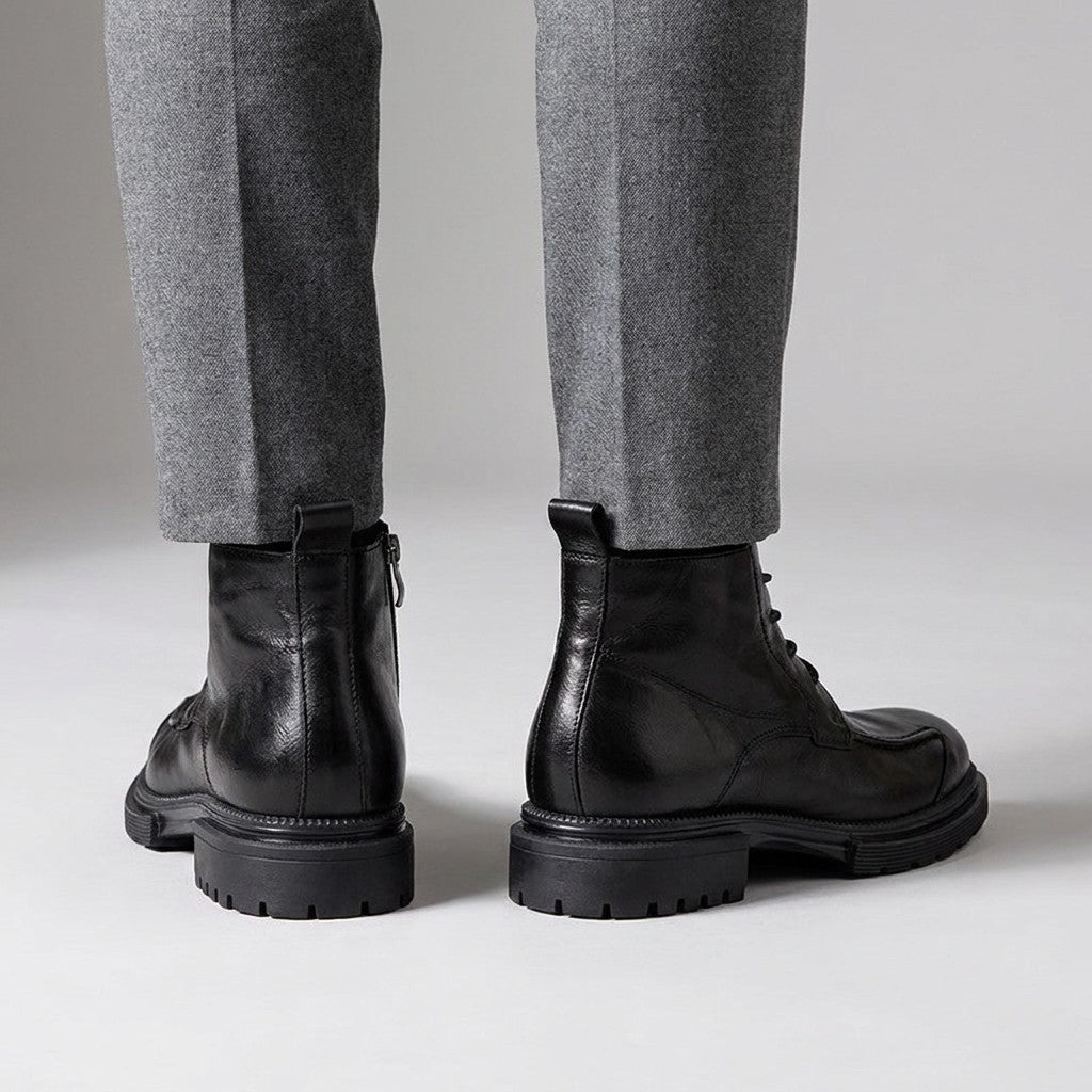 Back view of black Nils boots showing the heel pull loop and inner side zip