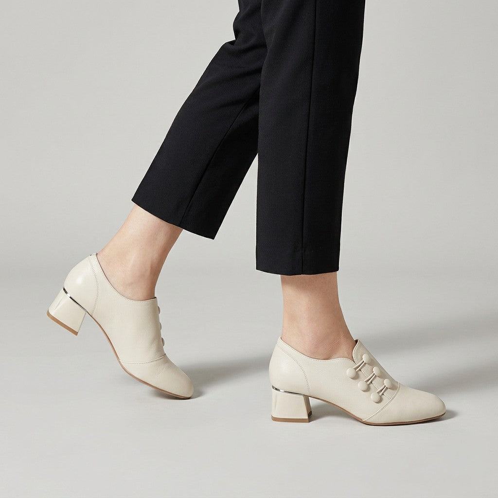 Cream Clemence shoe boots mid-stride with cropped black trousers