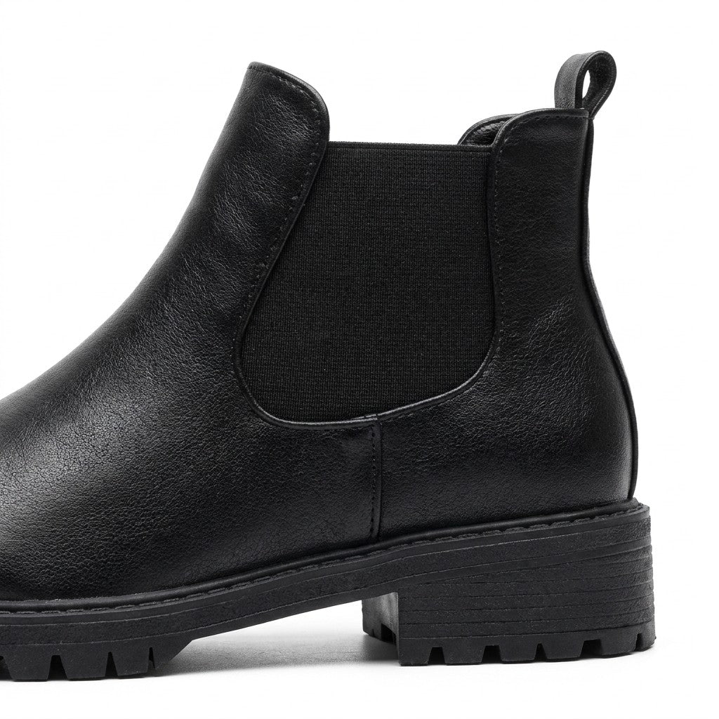Close-up of the Ines elastic gusset, back pull loop and deep-cleated rubber sole