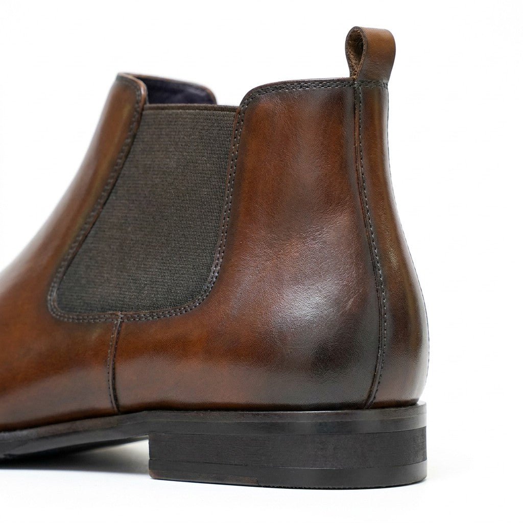 Close-up of the Jasper burnished heel, pull tab and elastic gusset