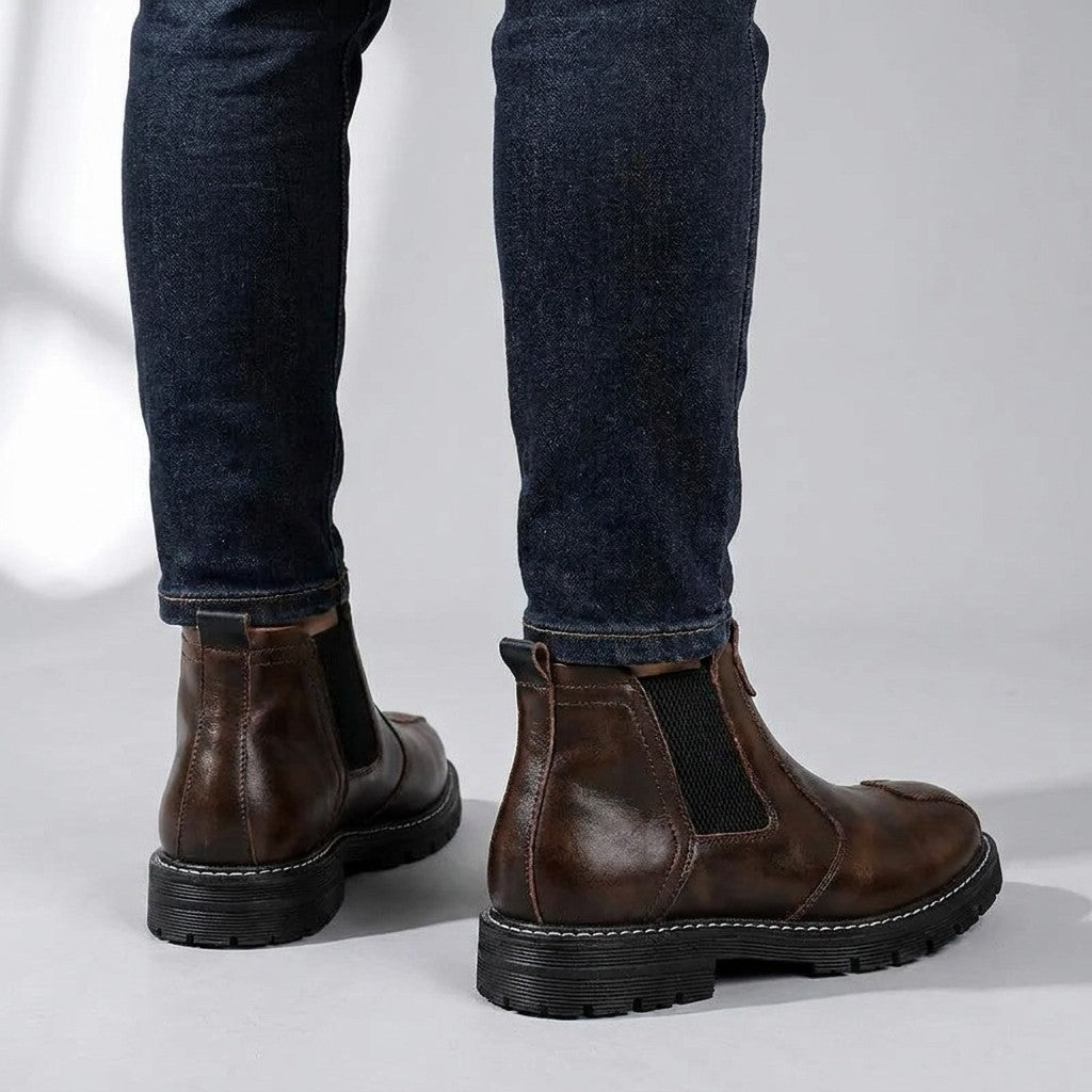 Back view of brown Henrik boots showing the heel pull tab and chunky lug sole