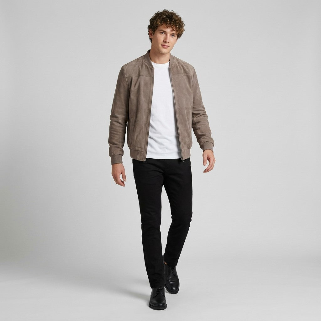 Model walking in the taupe Corvin suede bomber worn open with black trousers