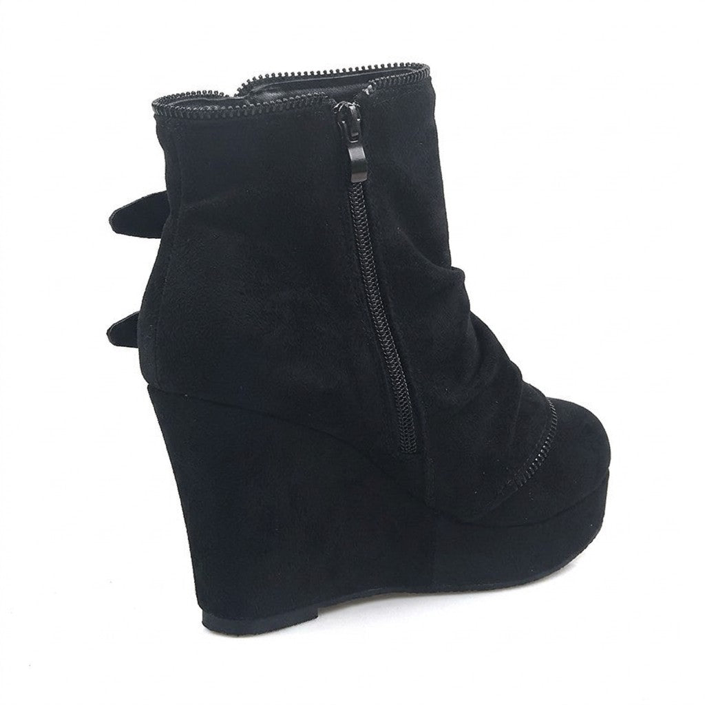 Inner side of the black Saskia boot showing the full-length side zip and suede-covered wedge