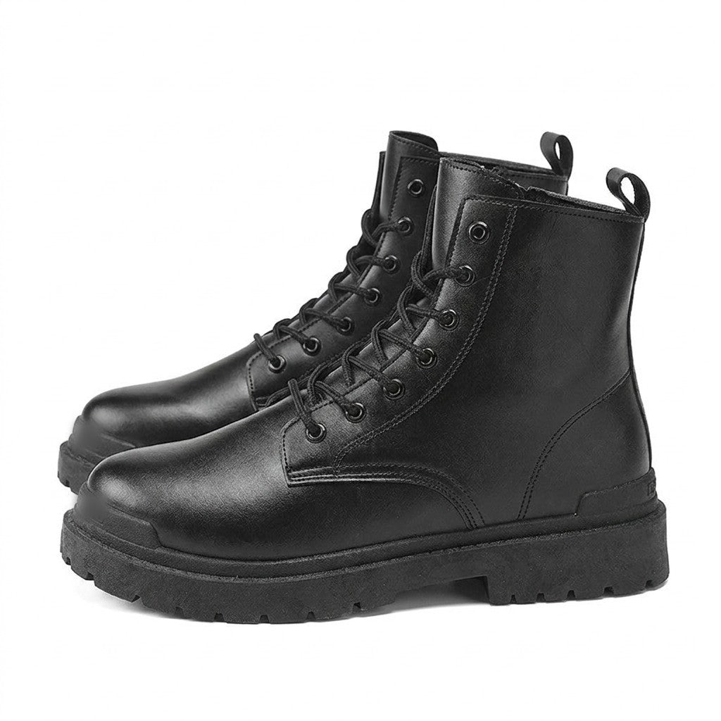 Pair of black Matthis men's leather work boots with lug soles, side view on white