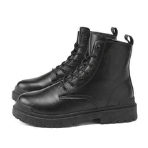 Pair of black Matthis men's leather work boots with lug soles, side view on white