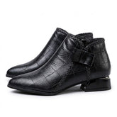 Pair of black Tamsin pointed ankle boots on white, outer side with leather bow and braided trim