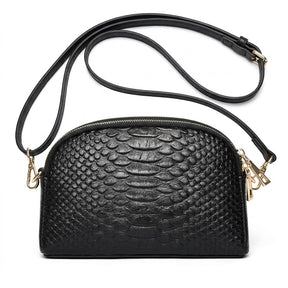Front view of the Isaure black croc-embossed leather half-moon crossbody bag with gold-tone hardware