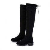 Pair of black Oriane suede over-the-knee boots on white, side view with low block heel