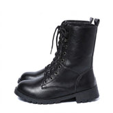 Pair of black Lysandra leather lace up boots with lug soles, side view on white