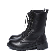 Pair of black Lysandra leather lace up boots with lug soles, side view on white