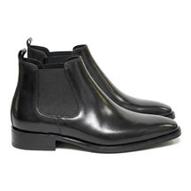 Pair of black polished Jasper men's Chelsea boots with chisel toe, side view on white