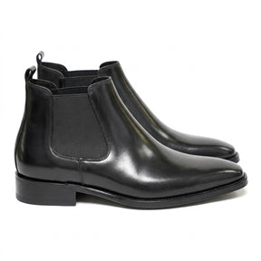 Pair of black polished Jasper men's Chelsea boots with chisel toe, side view on white