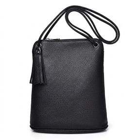 Front view of the black Solveig leather crossbody bag with tassel and cord strap on white