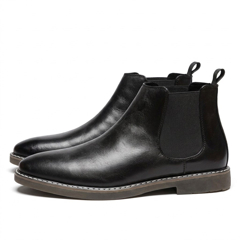 Pair of black Falk men's leather Chelsea boots on white, side view