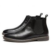 Pair of black Falk men's leather Chelsea boots on white, side view