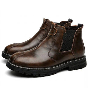 Pair of dark brown burnished Henrik men's rugged leather Chelsea boots on white, side view