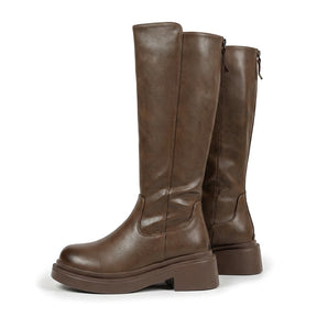 Pair of mocha brown Mirabel leather knee high boots with chunky platform soles on white