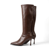 Pair of chocolate brown Maribel leather knee high boots with stiletto heels, side view on white
