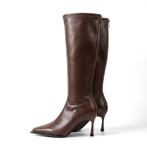 Pair of chocolate brown Maribel leather knee high boots with stiletto heels, side view on white