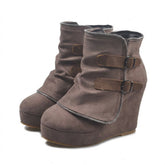 Pair of taupe Saskia suede wedge ankle boots on white, outer side with two buckled straps