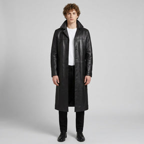 Model wearing the black Anselm long coat open over a white T-shirt, mid-calf length
