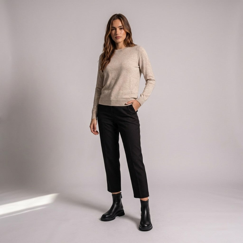 Model wearing black Liesel ankle boots with cropped black trousers and an oatmeal jumper