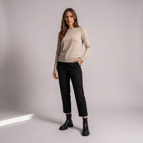 Model wearing black Liesel ankle boots with cropped black trousers and an oatmeal jumper