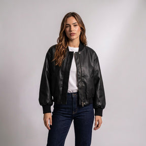Model wearing the Aurelia black leather bomber open over a white T-shirt with dark jeans