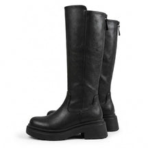 Pair of black Mirabel leather riding boots with treaded platform soles and back zip