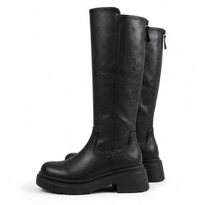 Pair of black Mirabel leather riding boots with treaded platform soles and back zip