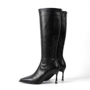 Pair of black Maribel leather knee high boots with pointed toes and silver heel tips on white