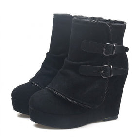 Pair of black Saskia suede wedge ankle boots on white with fold-over zip-trimmed panel