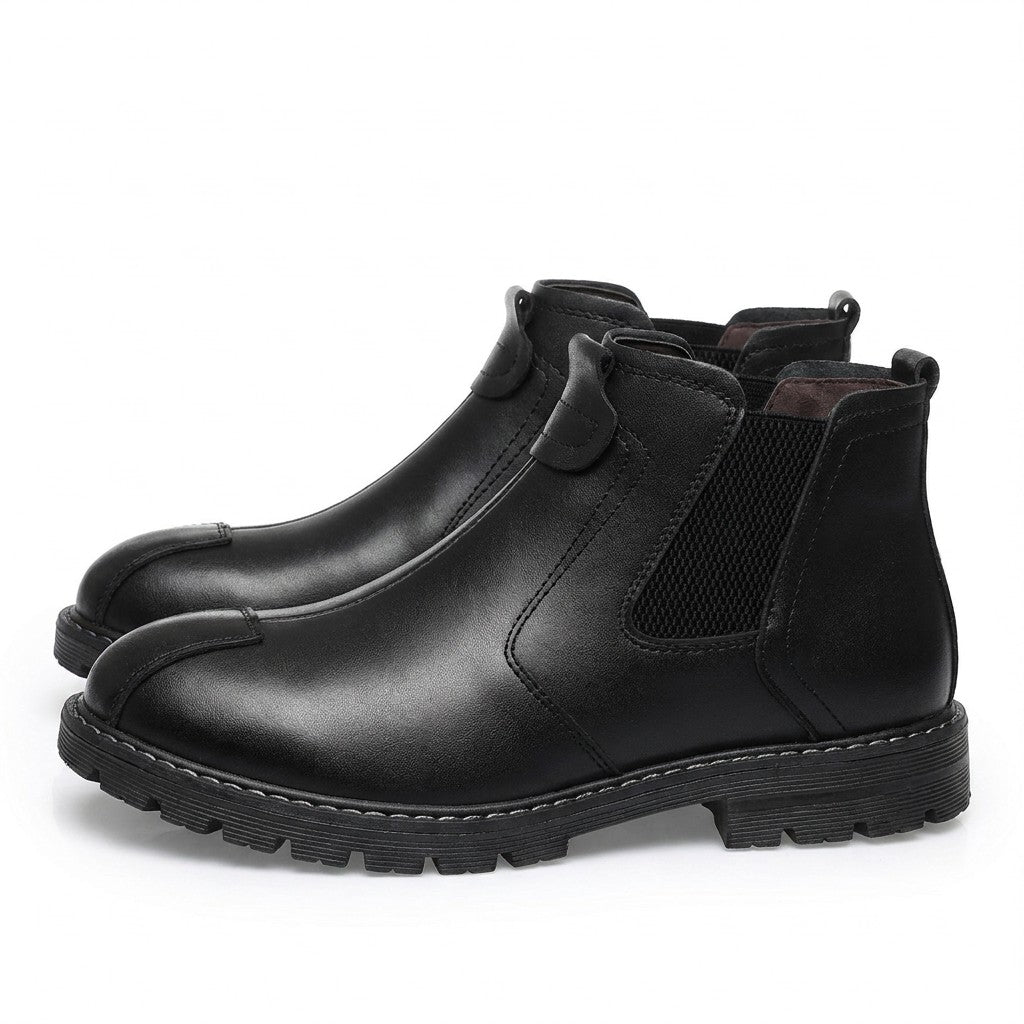 Pair of black Henrik Chelsea boots on white with front strap loop and white welt stitching