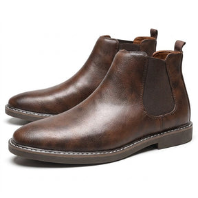 Pair of brown burnished Falk Chelsea boots on white with white welt stitching