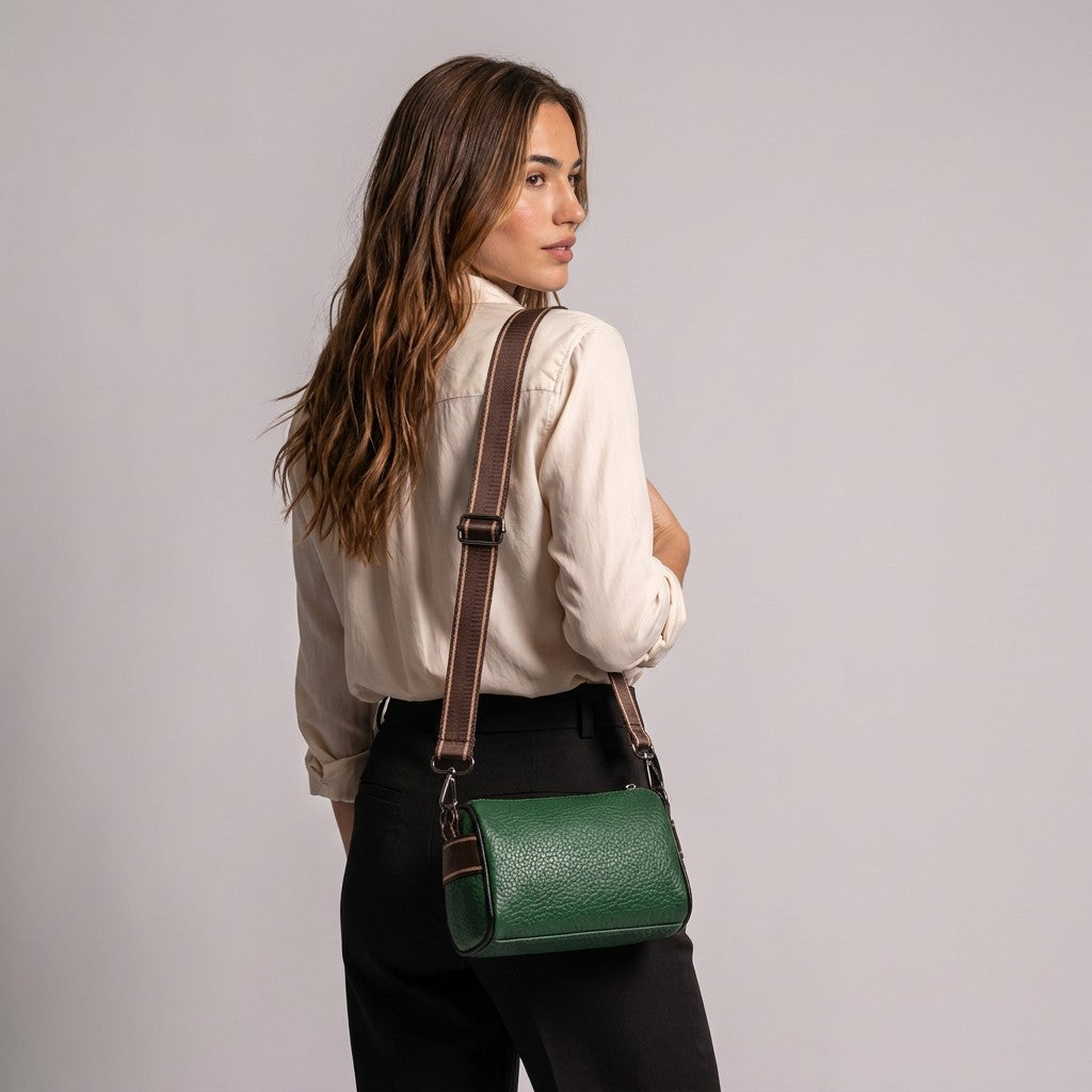 Back view of the model carrying the green Bellamy bag on her shoulder by its brown woven strap