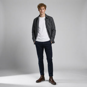 Model wearing brown Falk Chelsea boots with navy chinos and a grey overshirt