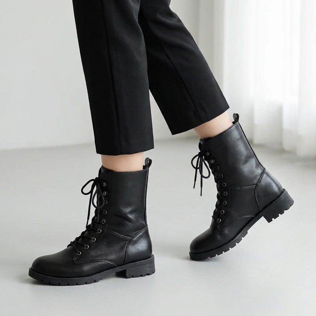 Lysandra black lace up boots mid-stride with cropped trousers
