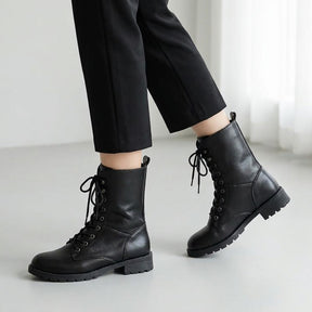Lysandra black lace up boots mid-stride with cropped trousers