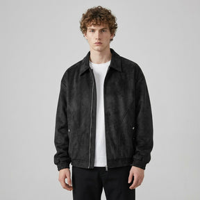 Model wearing the black Emeric jacket open, showing the dropped shoulders and elasticated hem