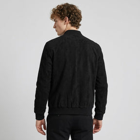 Back view of the black Corvin bomber on a model, plain suede back and ribbed waistband